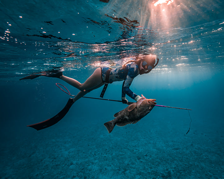 Woman spearfishing underwater