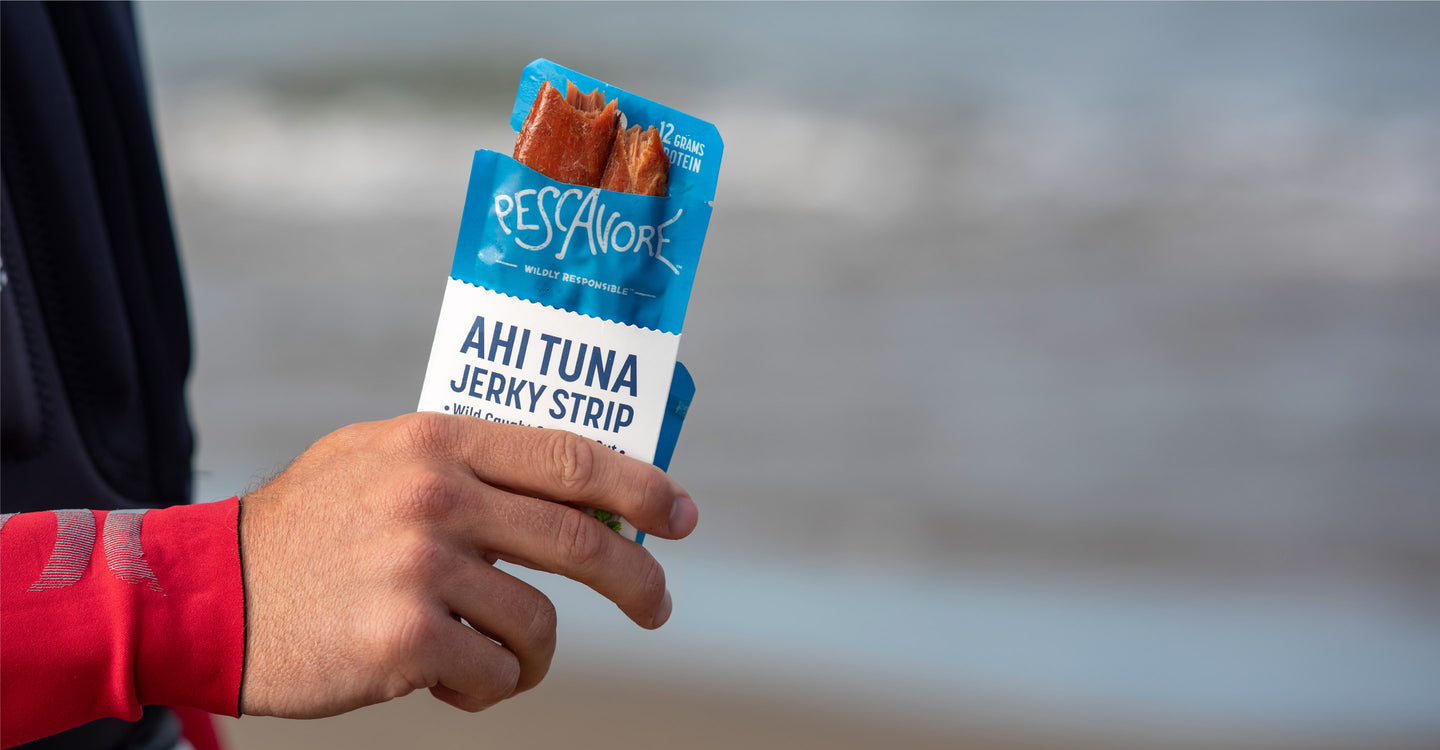 Person holding a package of Pescavore tuna jerky